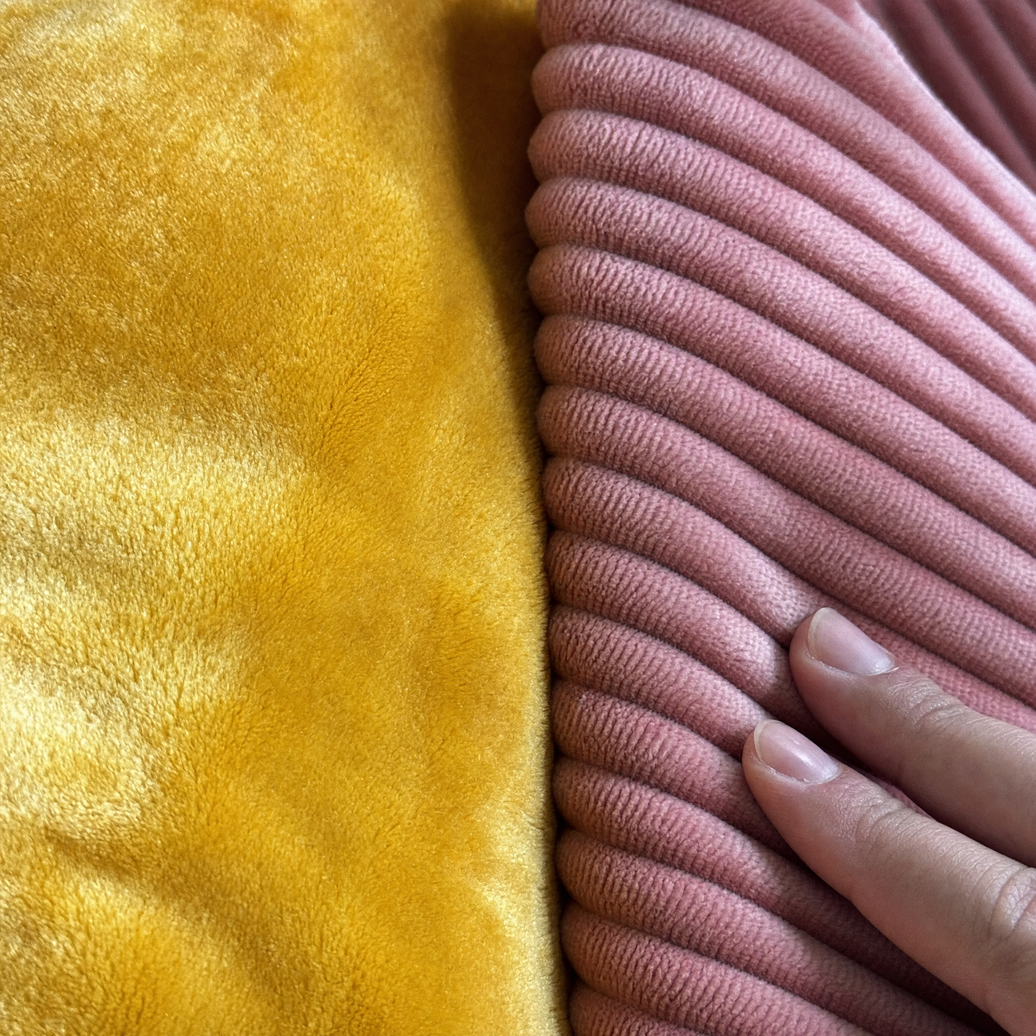 Close-up of both faces of the sensory cushion, crushed velvet and wide corduroy side by side